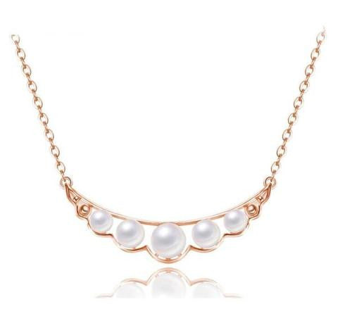 A rose gold necklace with 5 pieces of white pearl stones