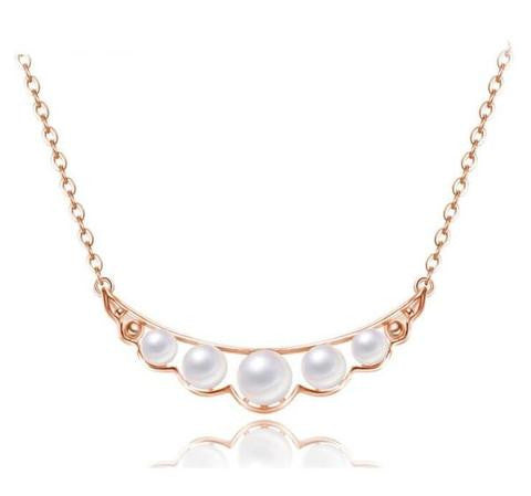 A rose gold necklace with 5 pieces of white pearl stones